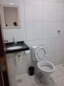 a bathroom with a toilet and a sink at Apartamento Premium Grand Luxo in Fortaleza