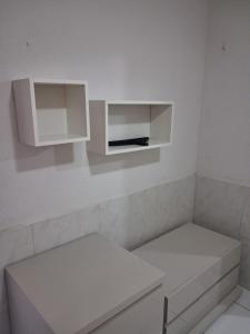 a room with two white cabinets in a white room at Apartamento Premium Grand Luxo in Fortaleza
