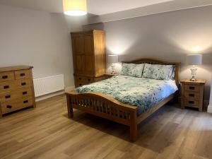 a bedroom with a bed and two night stands and a dresser at Self catering apartment Silvermines in Nenagh