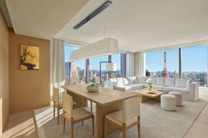 a living room with a dining table and a view of a city at The Tokyo EDITION, Toranomon in Tokyo