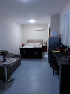 a living room with a couch and a bed at Paraíso nas férias in Porto Seguro +16 photos