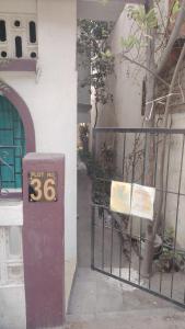 a gate with a sign on it next to a fence at fully furnish 5 bedroom 2 kitchen 4 bathroom home in Nagpur