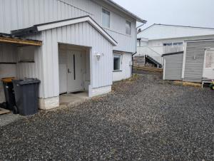 an empty driveway in front of a house at Comfy and cozy apartment in Tromsø