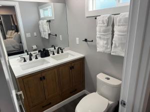 a bathroom with a sink and a toilet and a mirror at Relaxing and family friendly in Lacey +16 photos