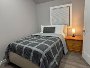 a bedroom with a bed and a lamp on a night stand at Relaxing and family friendly in Lacey