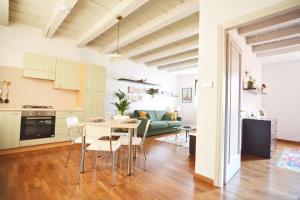 a kitchen and living room with a table and chairs at Il Sambuco - in pieno centro in Padova