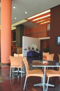 a dining room with a table and chairs at Suite Hotel Chrome - Beirut in Beirut