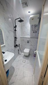 a white bathroom with a toilet and a sink at شقق فاخرة in Riyadh +10 photos