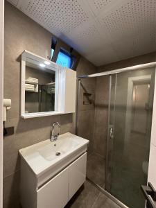 a bathroom with a sink and a shower at Erom Otel in Trabzon +14 photos