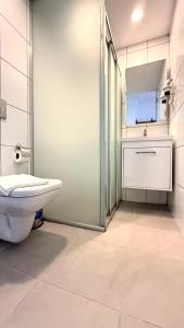 a bathroom with a toilet and a sink and a mirror at Casativo Hotel in Antalya +31 photos