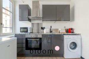 a kitchen with a washer and a washing machine at Le cocon Place du Marché Nancy coeur de ville in Nancy