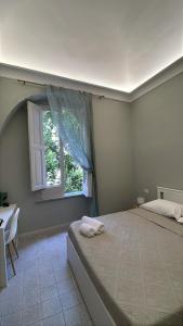 a bedroom with a large bed and a window at La Casa Del Monsignore in Torre del Greco +10 photos