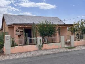 a house with a fence in front of it at Downtown Secluded Room 1 in Phoenix