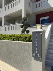 a sign for a hotel in front of a building at Almeta Suites in Chios