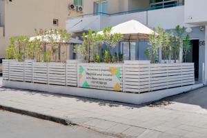 a building with two planters with plants in it at Atlantis Apartments 50m From Makenzy Seafront in Larnaka