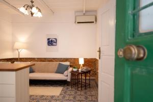 a living room with a couch and a table at The Psyri Collection in Athens