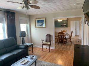 a living room with a couch and a table at Long Beach Lookout Vacation Rental in Twillingate
