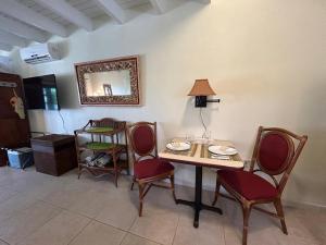 een kamer met een tafel, stoelen en een spiegel bij Paradera Palms 2 Bedroom in Paradera +7 foto's