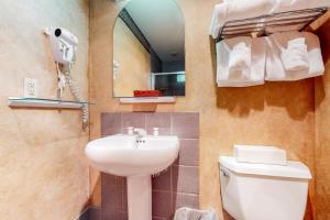 a bathroom with a sink and a toilet and a mirror at Shoshone 1909 in Big Sky +11 photos