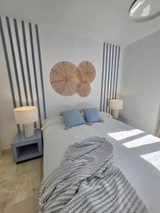 a bedroom with a bed with two lamps on it at Los Flamingos Villa Padierna Apartment in Estepona +42 photos