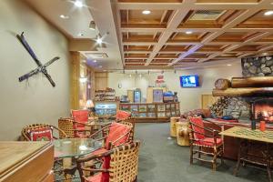 a room with tables and chairs and a couch at Shoshone 1965 in Big Sky