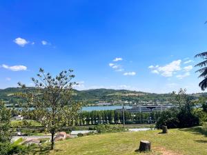 a view of a lake from a park at Appartement Ampuis Villa Monplaisir in Ampuis