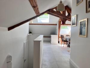 a kitchen and dining room with white walls and wooden beams at Appartement Ampuis Villa Monplaisir in Ampuis +12 photos