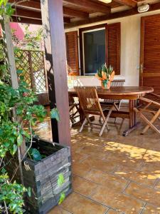 a patio with a wooden table and chairs at Villa Stintino in Stintino
