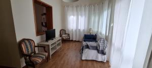 a small living room with a television and a chair at Casa di Monica e Mauro in Rome