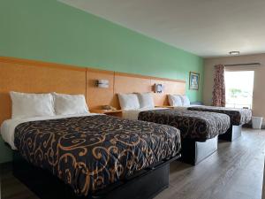 a hotel room with two beds and a window at Security Inn and Suites in Lake City