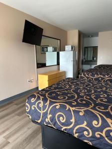 a hotel room with a bed and a refrigerator at Security Inn and Suites in Lake City