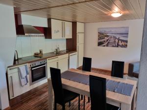 a kitchen and dining room with a table and chairs at Studio im Grünen in Schänis