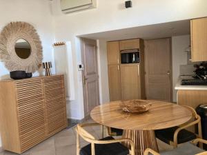 a kitchen with a wooden table in a room at Elegant 2 pièces au coeur du Cannet historique in Le Cannet +19 photos