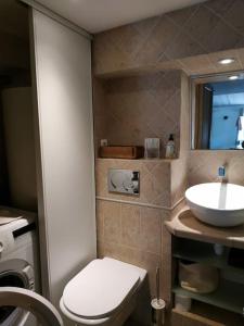 a bathroom with a white toilet and a sink at Elegant 2 pièces au coeur du Cannet historique in Le Cannet