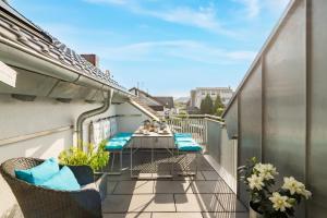 a balcony with chairs and a table on a building at Design-Apartments by Ulrike Horster in Bensheim