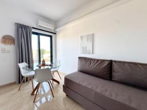 a living room with a couch and a table at Pachia Ammos Falasarna in Falasarna