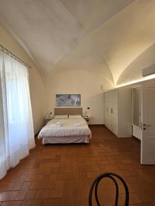 Ένα ή περισσότερα κρεβάτια σε δωμάτιο στο Villa Taccetti - Appartamento "Le Volte" in Villa del Settecento con piscina