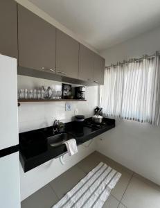 a kitchen with a sink and a counter top at Casa Loft Home Viva Parque in Cuiabá +7 photos