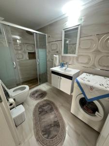 a bathroom with a toilet and a sink and a shower at Villa huzur in Marmaris
