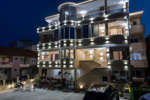 a large building with lights on it at night at Apartments DoriDitaRejjan in Ulcinj