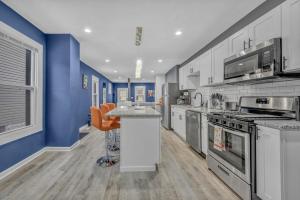 a kitchen with blue and white walls and a counter at Beautiful Tremont Jewel in Central Cleveland location in Cleveland
