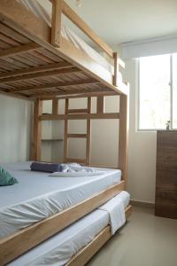 a bedroom with a wooden bunk bed with a window at apartamento con alma 888 in Coveñitas +32 photos