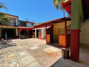 a group of buildings with a patio in the middle at La casa de la abuela in Palenque +26 photos