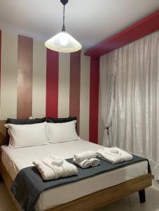 a bedroom with a bed with towels on it at Alba House in Prinos
