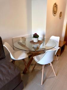 a glass table and chairs in a living room at Pachia Ammos Falasarna in Falasarna