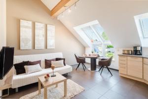 a living room with a couch and a table at Design-Wohnungen by Ulrike Horster in Bensheim