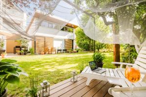 a patio with a table and a laptop on it at Design-Wohnungen by Ulrike Horster in Bensheim