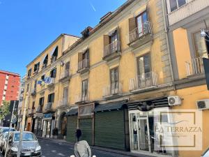 a building on a city street with a store at La Terrazza in Castellammare di Stabia