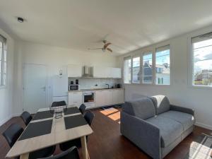 a living room with a table and a couch at Echappée Paimpolaise in Paimpol +37 photos