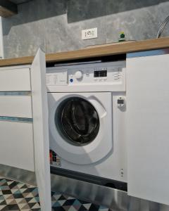 a washing machine in a kitchen with a counter at Alis home 100 mt dal mare in Loano